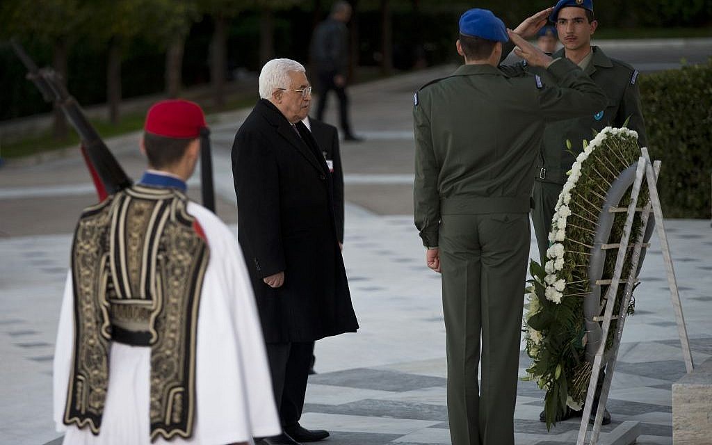 PA President Mahmoud Abbas pays tribute during a wreath laying ceremony at the Tomb of the Unknown Soldier in central Athens, on Monday, December 21, 2015 (AP Photo/Petros Giannakouris)