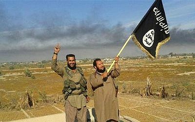 Illustrative photo of Islamic State militants, with an IS fighter waving the group flag in Fallujah, Iraq, west of Baghdad, June 28, 2015. (Militant website of IS, via AP)