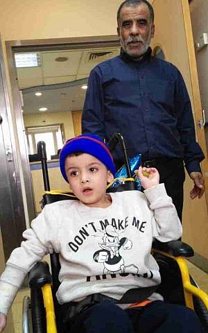 Hussein Dawabshe with his grandson Ahmad at Tel Hashomer hospital, December 23, 2015 (Simona Weinglass/Times of Israel)