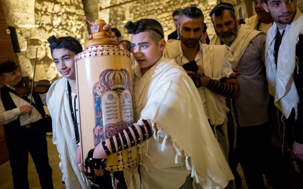 13-year-old Naor Ben-Ezra carrying a torah scroll as he celebrates his Bar Mitzvah at the Western Wall in Jerusalem's Old City, December 17, 2015 (Yonatan Sindel/Flash90
