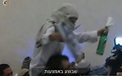 A far-right Israeli wedding-goer celebrates the murder of the Dawabsha family (screen capture: Channel 10)