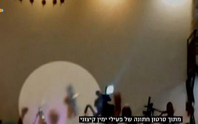 Far-right Israeli wedding-goers stab a photo of 18-month-old Ali Dawabshe, killed in a deadly firebombing attack, allegedly by Jewish extremists, in July 2015 (screen capture: Channel 10)