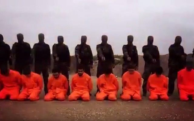 An image from video released on December 7, 2015, appears to show Syrian rebels lining up Islamic State fighters in preparation for mass execution – only to spare them at the last minute and jail them instead. (screen capture: YouTube)