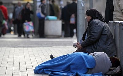 Illustrative photo of a poor woman begging for money in Jerusalem. (Nati Shohat/Flash90)