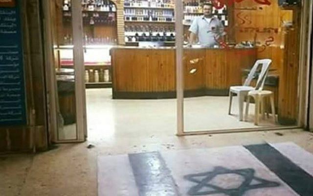 An Irbid, Jordan, shopowner who painted an Israeli flag on the floor of his store. (Facebook screen capture)