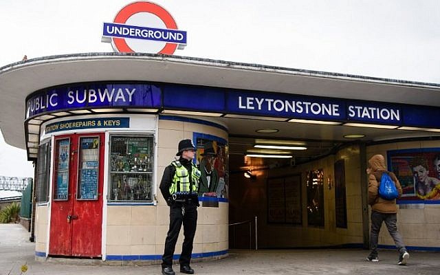 A police officer stands guard outside Leytonstone station in north London on December 6, 2015, a day after three people were stabbed in what police are treating as a 'terrorist incident.' (AFP/Leon Neal)