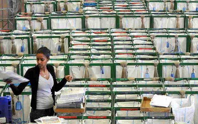 A postal worker stands in the selection hall at a post office in Tel Aviv February, 22, 2010. (Yossi Zeliger/Flash 90)