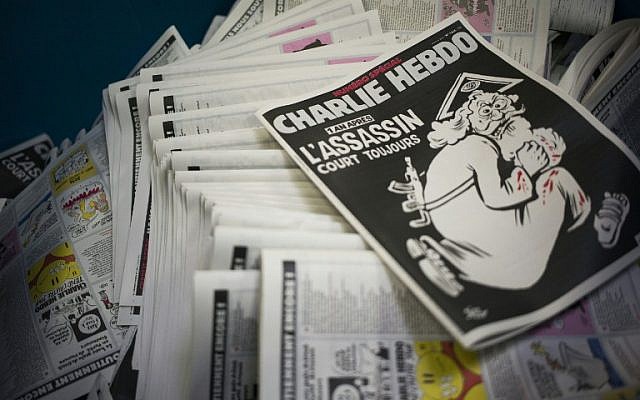 A photo taken on January 4, 2016, at a printing house near Paris shows the cover of the latest edition of the French satirical magazine Charlie Hebdo, bearing a headline that translates as 'One year on: The assassin still at large,' in an edition to mark the first anniversary of the terror attack. (AFP/Martin Bureau)
