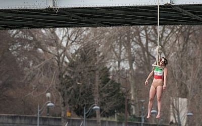 Illustrative: An activist hangs from a noose-like rope from a Paris bridge to call attention to the large number of executions in Iran, January 28, 2016. (AP Photo/Zacharie Scheurer)