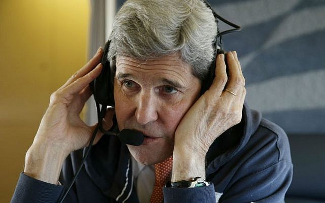 US Secretary of State John Kerry aboard his plane Saturday, Jan. 16, 2016, on his way to Vienna, Austria for "implementation day," the day the International Atomic Energy Agency (IAEA) verifies that Iran has met all conditions under the nuclear deal. (Kevin Lamarque/Pool Photo via AP)