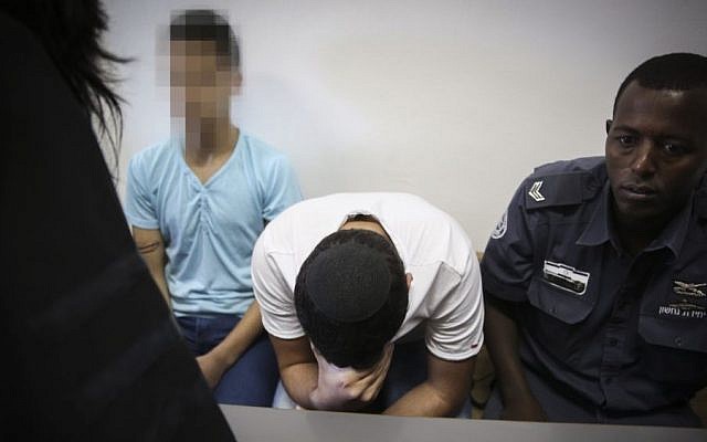 Police escort two Jewish minors, suspected of taking part in the murder of Muhammed Abu Khdeir, at the Jerusalem District Court, Jerusalem, June 3, 2015. (Hadas Parush/Flash90)