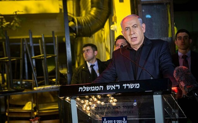 Prime Minister Benjamin Netanyahu speaks to press after lighting a candle outside a pub on Dizengoff Street in central Tel Aviv, January 02, 2016, a day after two people were killed in a shooting at the bar. (Miriam Alster/Flash90)