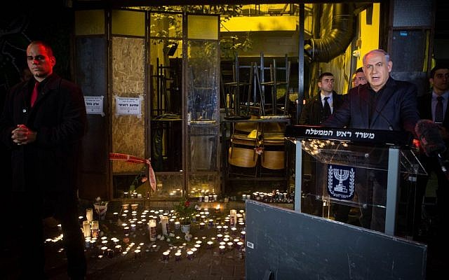Prime Minister Benjamin Netanyahu speaks to the press after lighting a candle outside a pub on Dizengoff Street , the scene of deadly shooting attack, Tel Aviv, January 2, 2016. (Miriam Alster/Flash90)