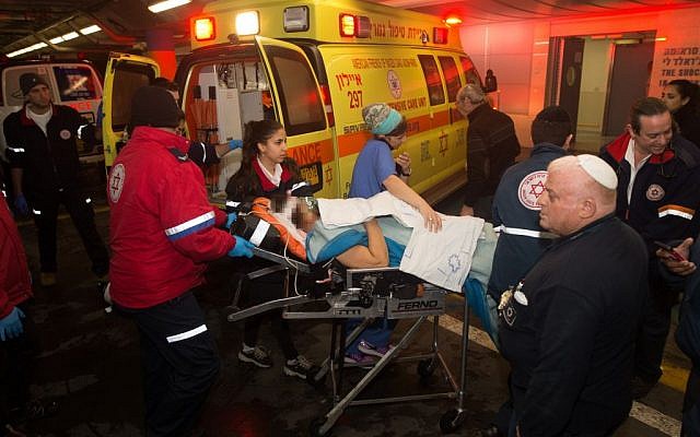 Medics wheel a wounded Israeli woman into the emergency room of the Shaare Zedek Medical Center on January 25, 2016. She was one of two Israeli women injured in a stabbing attack at the entrance to Beit Horon, in the West Bank. (Yonatan Sindel/Flash90)
