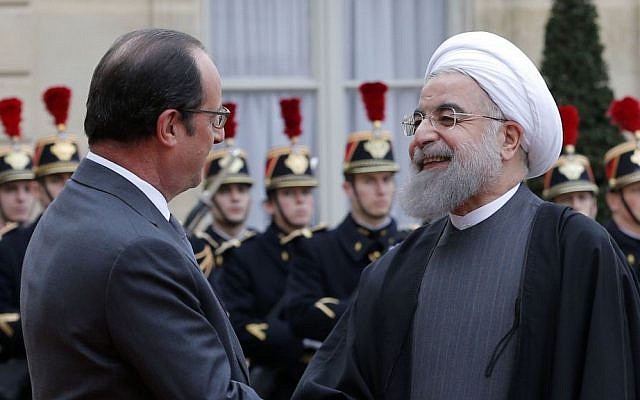 French President Francois Hollande greets Iranian President Hassan Rouhani before a meeting at the Elysee Palace, in Paris, Thursday, January 28, 2016. (AP Photo/Christophe Ena)