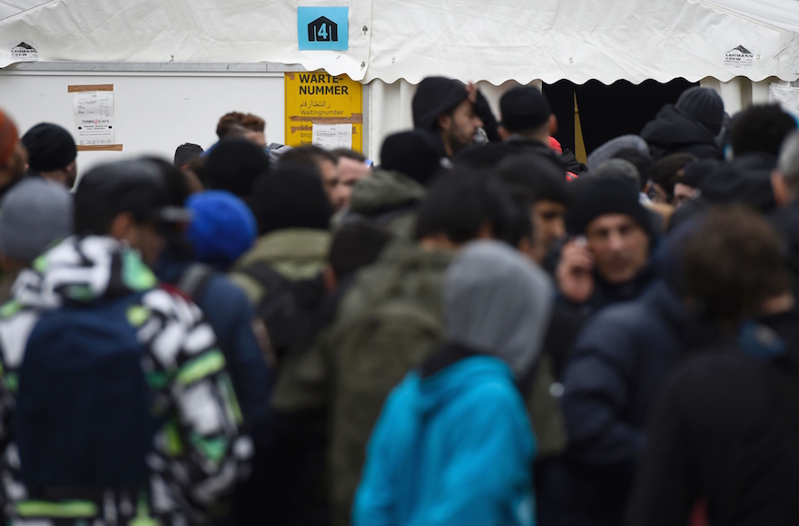 Migrants queue up next to a tent at the State Office of Health and Social Affairs (LAGeSo) in Berlin on January 27, 2016. (TOBIAS SCHWARZ/AFP/Getty Images)