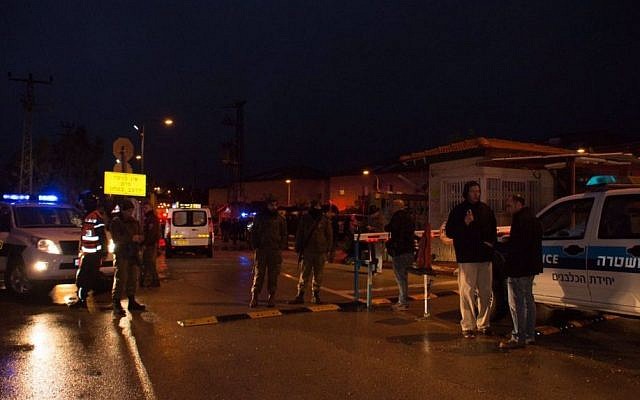 Police officers and emergency service employees at the scene of a terror attack in which two people were wounded by two Palestinian stabbers, in the West Bank settlement of Beit Horon on Monday, January 25 2016 .(Israel Police)