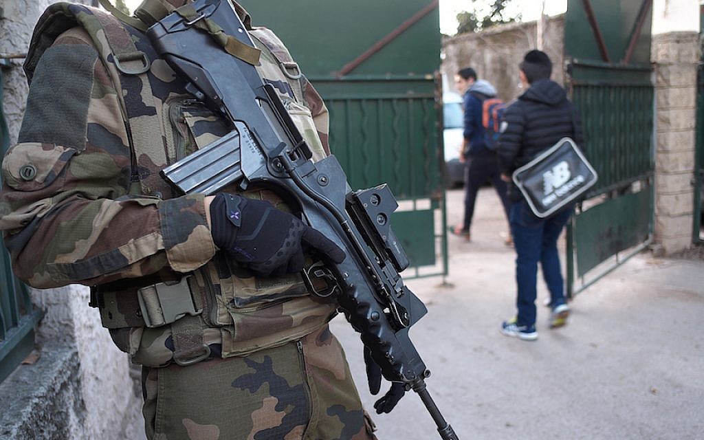 An armed French soldier securing the access to the La Source Jewish school in Marseille, southern France a day after a teenager, armed with a machete and a knife, wounded a teacher slightly before being stopped and arrested, Jan. 12, 2016. (Boris Horvat/AFP/Getty Images, via JTA)