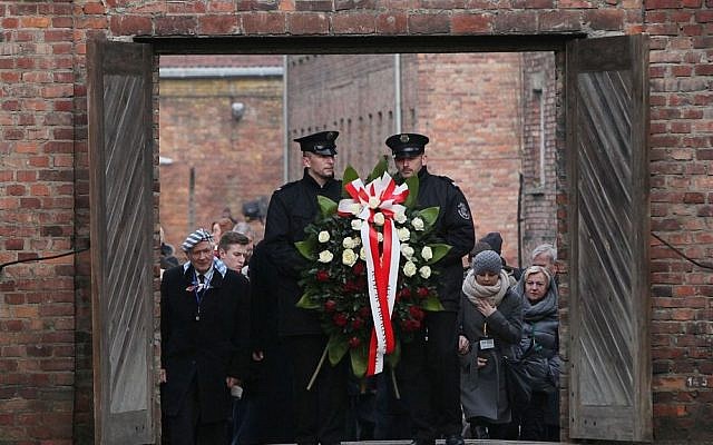 Soldiers hold a wreath at the former Auschwitz Nazi death camp in Oswiecim, Poland on January 27, 2016, at the 71st anniversary of the death camp's liberation by the Soviet Red Army in 1945. (AP Photo/Czarek Sokolowski)