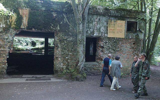 In this July 17, 2004 file photo, tourists visit the ruins of Adolf Hitler's headquarters in the bunker Wolf Lair in Gierloz, northeastern Poland. (AP Photo/Czarek Sokolowski, File)