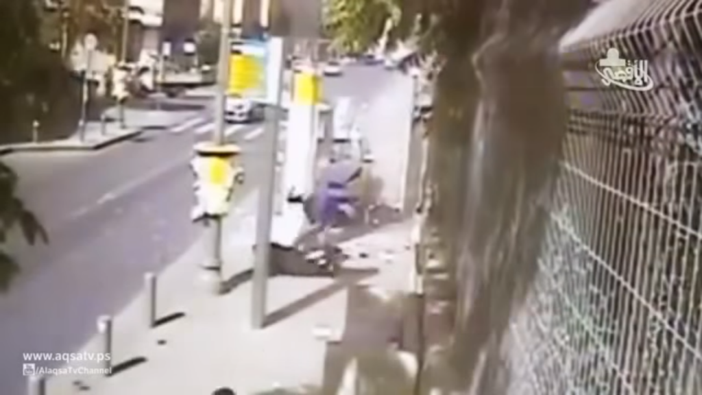 Footage of Alaa Abu Jamal stabbing passers-by in a Jerusalem terror attack on October 15, 2014. The attack is praised in the song "Lovers of Stabbing" while the clip plays in the background. (screen capture: YouTube)