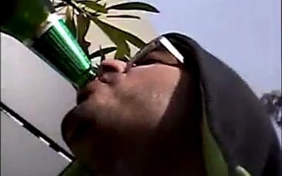 A still image of Tel Aviv gunman Nashat Milhem drinking beer taken from a series of undated videos released January 27, 2016 by the Shin Bet security service. (screen capture)