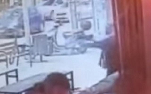 Footage from the scene shows a suspected Arab Israeli gunman emerging form a nearby store and opening fire during a January 1, 2016 attack that killed two people at a Tel Aviv bar (screen capture: YouTube)