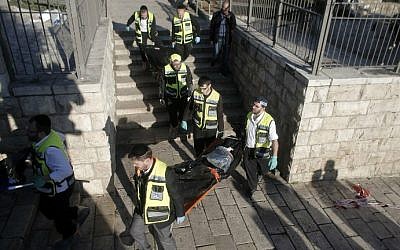 Medics carry the bodies of two Palestinian attackers killed during a shooting and stabbing assault at Damascus Gate, outside Jerusalem's Old City on February 3, 2016. (Ahmad Gharabli/AFP)