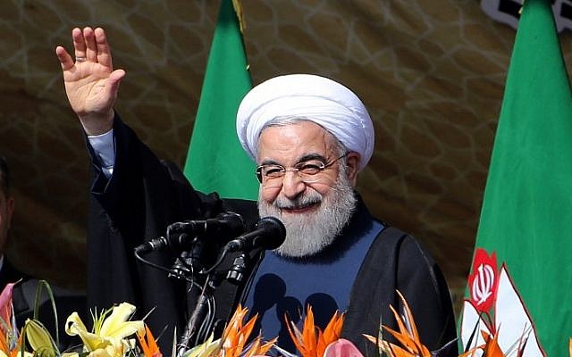 Iranian President Hassan Rouhani waves to the crowd during a rally in Tehran's Azadi Square (Freedom Square) to mark the 37th anniversary of the Islamic revolution on February 11, 2016. (Atta Kenare/AFP)