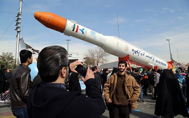 Illustrative: Iranians take photos of the Simorgh satellite rocket during celebrations to mark the 37th anniversary of the Islamic Revolution, in Tehran, February 11, 2016. (AFP/Atta Kenare)