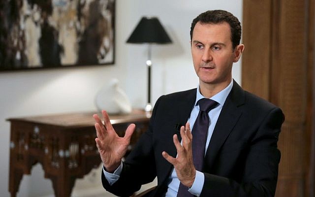Syrian President Bashar Assad gestures during an interview in the capital Damascus on February 11, 2016. (AFP/Joseph Eid)