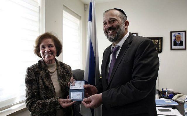 German Nazi-hunter Beate Klarsfeld (L) receives her new Israeli passport and ID from Interior Minister Aryeh Deri during a ceremony at the Interior Ministry in Jerusalem, February 15, 2016. (Thomas Coex/AFP)