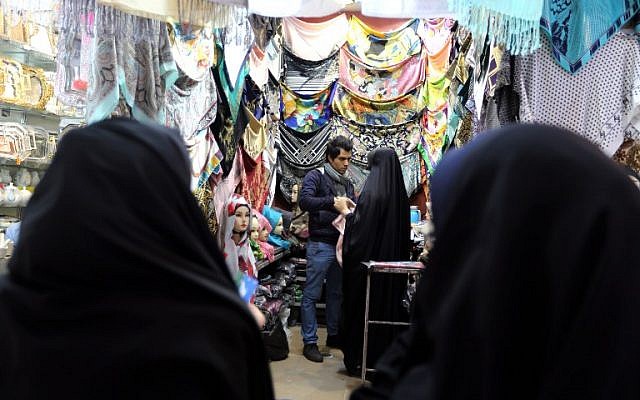 Iranian women shop for scarves at the ancient Grand Bazaar of the holy city of Qom, 130 kilometers south of Tehran, on February 24, 2016. (AFP / ATTA KENARE)