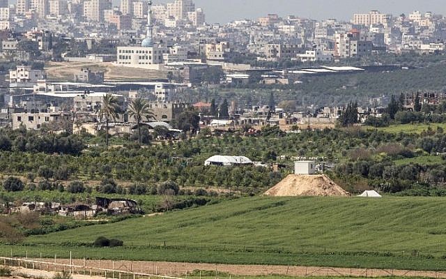 File: A photo taken from the Israeli side of the border with the Gaza Strip shows a Hamas outpost on a hill (right) along the border, February 25, 2016. (AFP/Jack Guez)