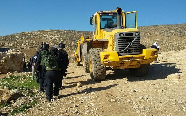 Soldiers from Israel's Civil Administration demolish a number of structures deemed illegal in the southern Hebron Hills on February 2, 2016. (Nasser Nawaja/B'Tselem)