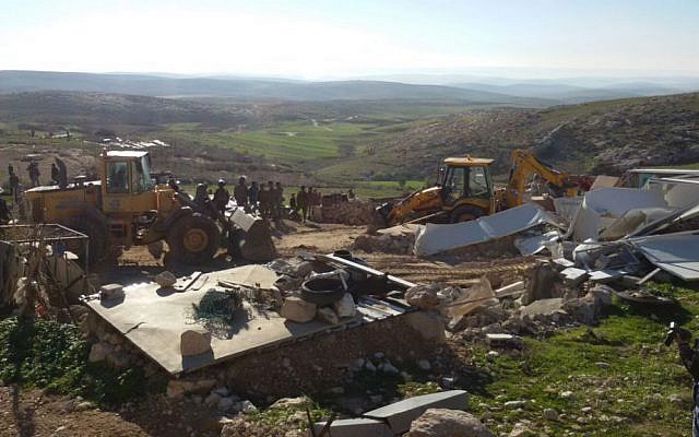 Soldiers from Israel's Civil Administration demolish a number of structures deemed illegal in the southern Hebron Hills on February 2, 2016. (Nasser Nawaja/B'Tselem)
