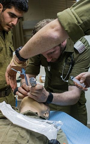 An IDF paramedic practices intubation on a smart doll that mimics the human respiratory system in the Medical Simulation Center at Tel Hashomer Hospital in Ramat Gan on February 11, 2016. (Adi Brown/IDF Spokesperson's Unit)