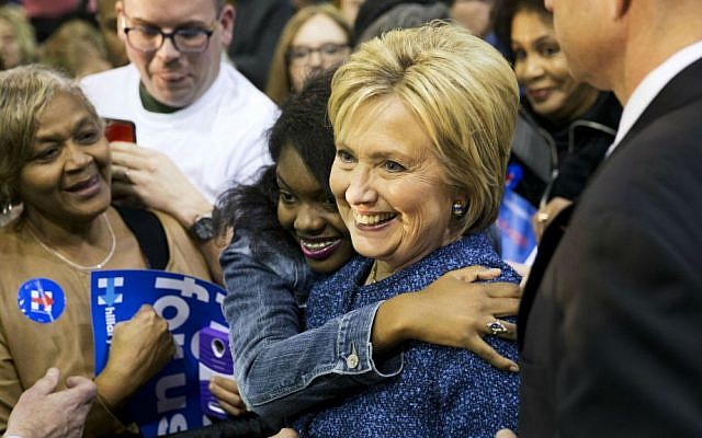 Democratic presidential candidate Hillary Clinton is embraced by an audience member while posing for a photo at a campaign event at Miles College Saturday, Feb. 27, 2016, in Fairfield, Alabama. (AP Photo/David Goldman)