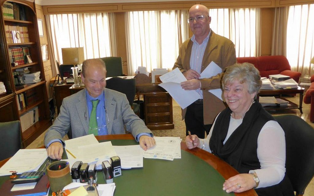 Doreen Alhadeff (right) signing her Spanish citizenship papers in the presence of public notary Pedro Bosch (left) and Jesus Cantero Morenos, his legal assistant, on February 2, 2016 in Torremolinos, Spain. (Joseph S. Alhadeff)