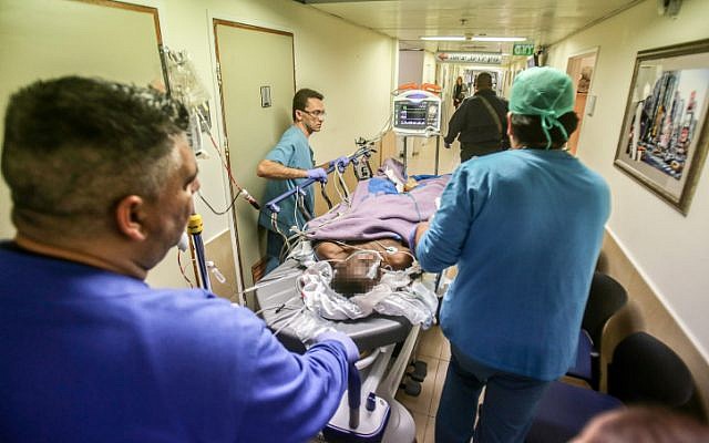 Medical personnel rush Kamel Hassan Mohammed into the emergency unit at Barzilai Hospital in Ashkelon after he stabbed a soldier in the southern city, on February 7, 2016. (Edi Israel/Flash90)