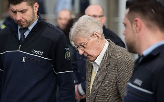 94-year-old former SS guard at the Auschwitz death camp Reinhold Hanning, center, leaves the building after the opening of his trial in Detmold, Germany, Thursday, Feb. 11, 2016.  (Bernd Thissen/Pool Photo via AP)