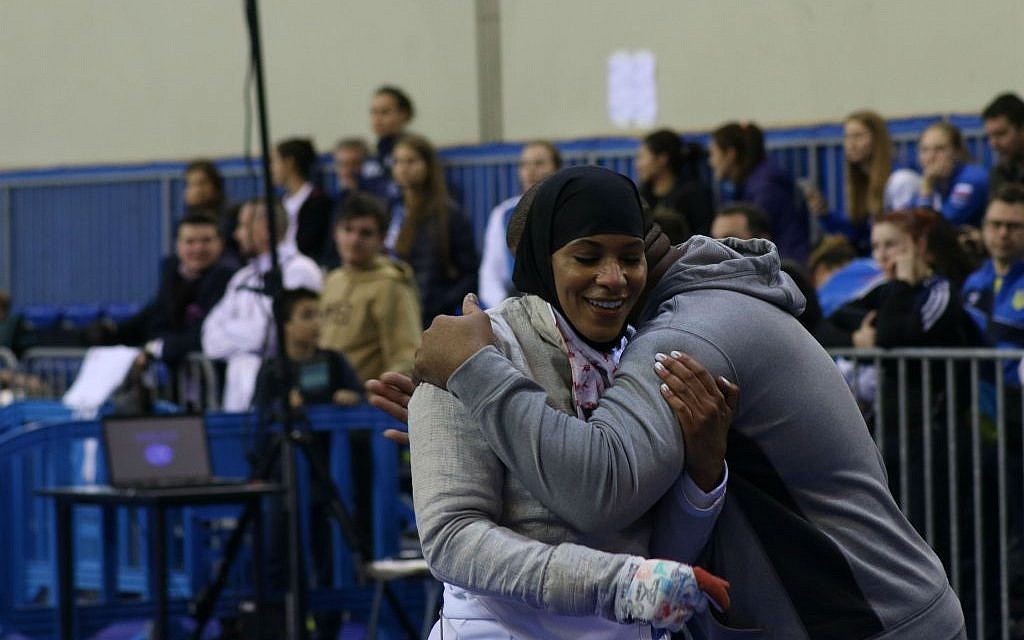US fencer Ibtihaj Muhammad celebrates with coach Akhi Spencer-El after winning a bronze medal at the Athens World Cup, held from January 29-31, 2016. (Jeremy Summers)