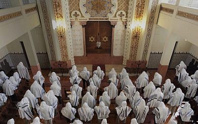 Illustrative: Congregants praying at the Kadoorie – Mekor Haim synagogue in Porto, Portugal, May 2014. (Courtesy of the Jewish Community of Porto)