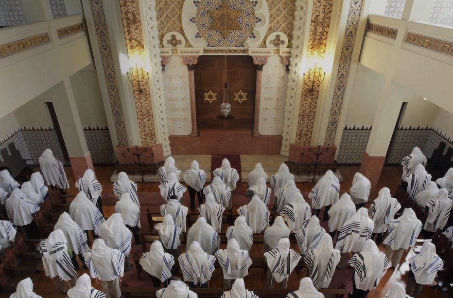 Congregants praying at the Kadoorie – Mekor Haim synagogue in Porto, Portugal, May 2014. (Courtesy of the Jewish Community of Porto)