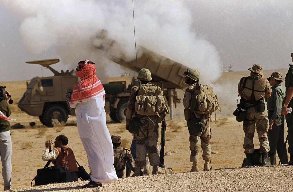 In this Dec. 16, 1990 file photo, a Saudi Arabian official and Saudi soldiers watch a multiple rocket launch system near the Kuwaiti border in Saudi Arabia. (AP Photo/Bob Daugherty, File) 