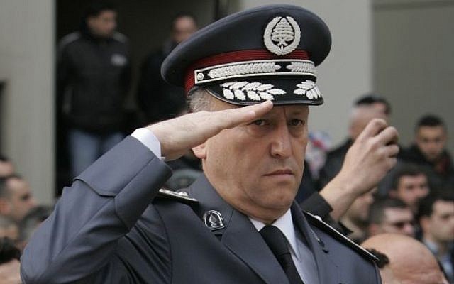 Lebanese Brig. Gen. Ashraf Rifi salutes as he stands next to the coffin of a soldier killed by a car bomb during his funeral in Beirut on  Jan. 26, 2008. (AP Photo/Hussein Malla, File)
