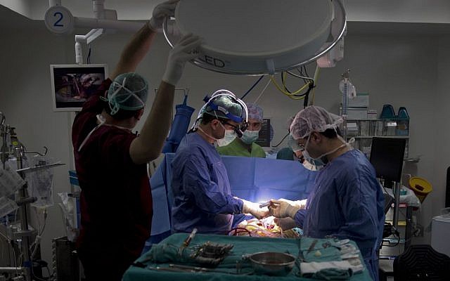 Palestinian cardiovascular surgeon Saleem Haj-Yahia (left), performs open-heart surgery at al-Najah University Hospital in the West Bank city of Nablus, January 28, 2016. (AP/Majdi Mohammed)