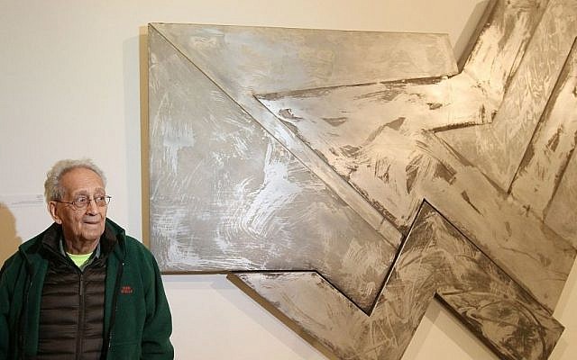 US artist Frank Stella poses in front of one of his works at an exhibition devoted to him in Warsaw, Poland, Thursday, February 18, 2016 (AP Photo/Czarek Sokolowski)
