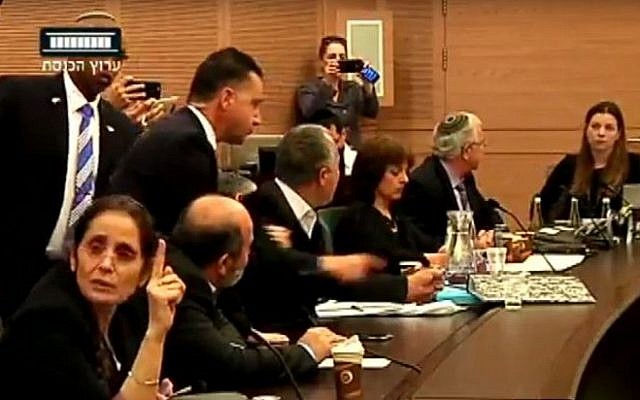 The Knesset's Constitution, Law and Justice Committee erupts in angry debate on February 29, 2016, and a Knesset security staffer prepares to eject MK Abdullah Abu Maaruf (Knesset channel screenshot)