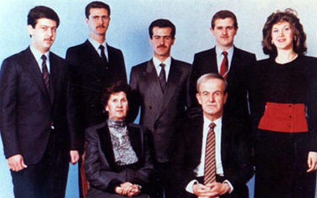 The Assad family in a photo taken at un unknown date. Hafez Assad and his wife, Aniseh Makhlouf are seated in front. behind them, from left to right: Maher, Bashar, Bassel, Majd, and Bushra Assad. (Public Domain